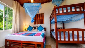 A room with a bed, a wooden bench, and a window overlooking greenery. - Your Private Mountain Escape in Kandy - Eagles' Nest (Moragolla)