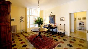 A room with a round table, a chair, a radiator, and a large window. - Villa with unique view of Siena with private pool (Ascarello)