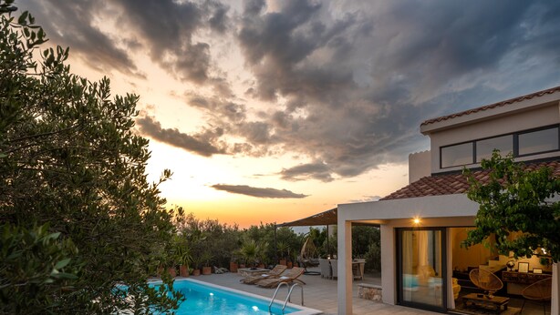 A pool area with lounge chairs, a covered seating area, and a view of the sunset. - Eclectic Villa with Swimming Pool set in it's own Olive Grove (Stari Grad)