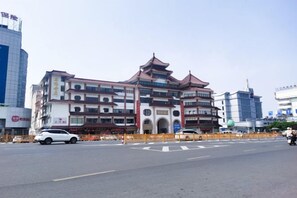 A multi-story building with traditional architectural design, featuring a central courtyard and multiple balconies.