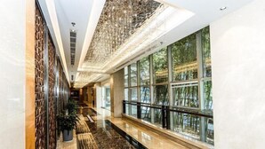 A modern hotel corridor with a marble floor, large windows, and a decorative ceiling. - Jinling Danyang Hotel (Danyang)