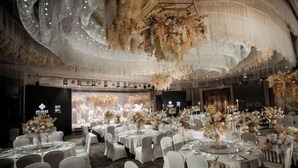 A banquet hall with round tables set for a formal event, featuring floral centerpieces and white tablecloths. - Jinling Danyang Hotel (Danyang)