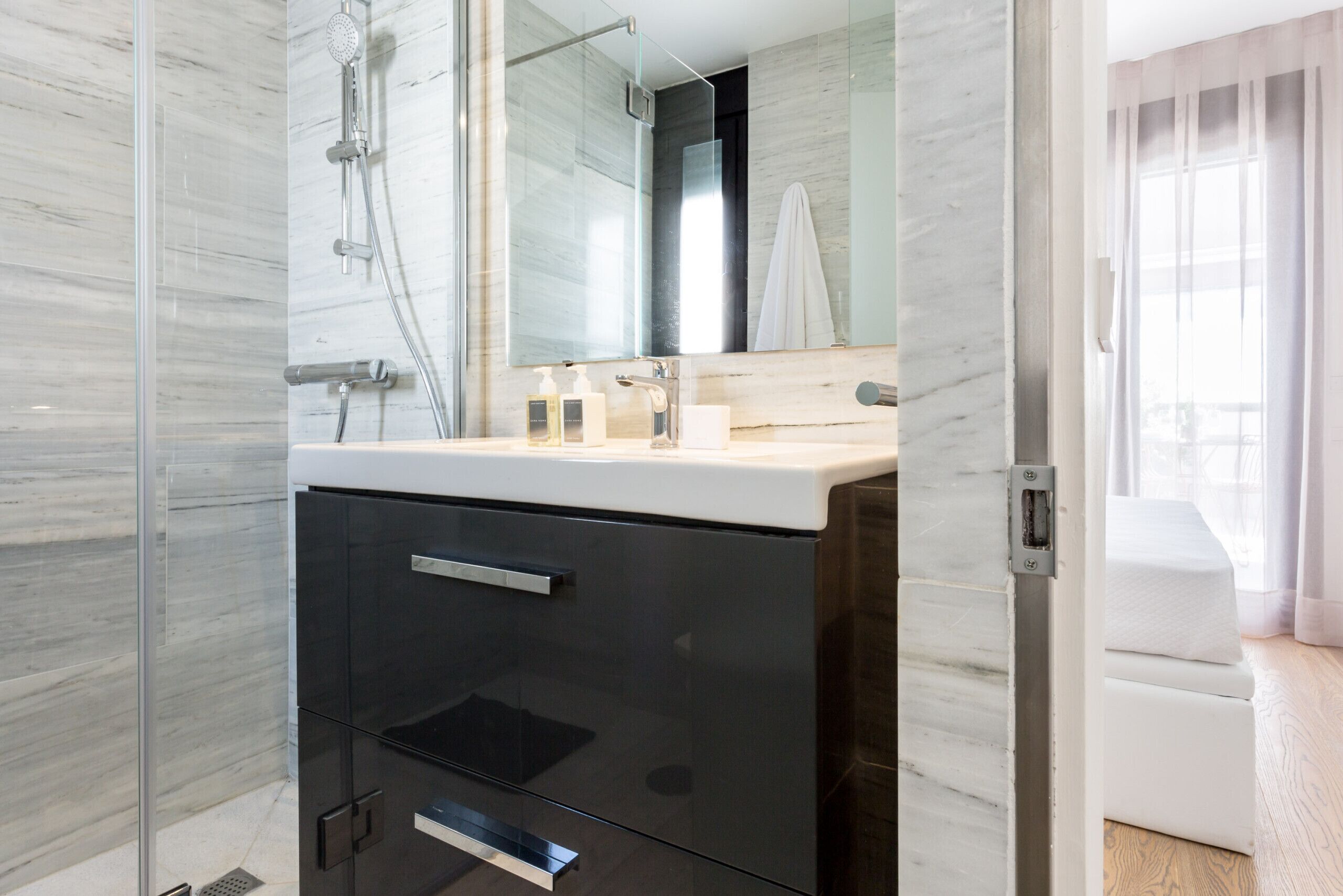 Shower, rainfall showerhead, hair dryer, towels