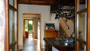 A kitchen with a tiled floor, wooden cabinets, a sink, and hanging pots. - Villa on Chianti hill in heart of Tuscany, super-large pool, 14 ha plot (Gaiole in Chianti, Prov. Siena, Toscana)