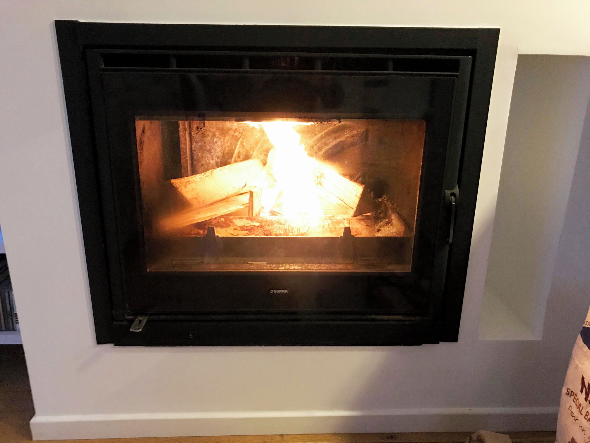 A fireplace with visible logs and flames.