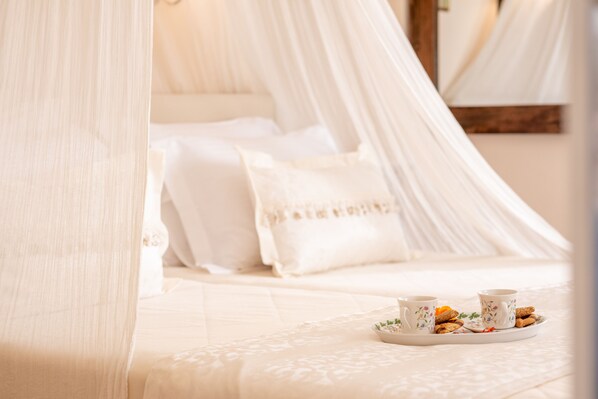 A bed with a canopy, pillows, and a tray with cookies and tea cups. - Villa Kallergi - Nefeli (450 m2) House for 6, west-central Crete (Rethymnon)