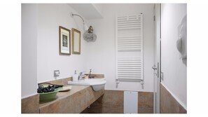 A bathroom with a sink, mirror, towel rack, and a door. - CASA SANGREGORIO FLAT: AT HOME IN THE OLD NAPLES (Napoli)