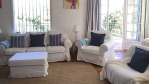 A living room with white furniture, a rug, and a painting on the wall. - Villa With Pool In St Paul En Foret, Nr Fayence, Cote D'azur-Provence, France (Saint-Paul-En-Forêt)