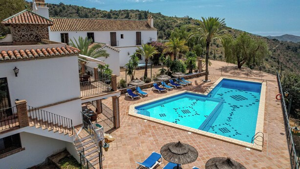 A swimming pool with lounge chairs, a staircase, and a view of a hilly landscape. - Jasmine Padre Aviles 17th C converted convent with pool, tennis & amazing views (Malaga)