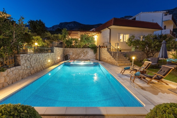 House view from lower terrace at night.