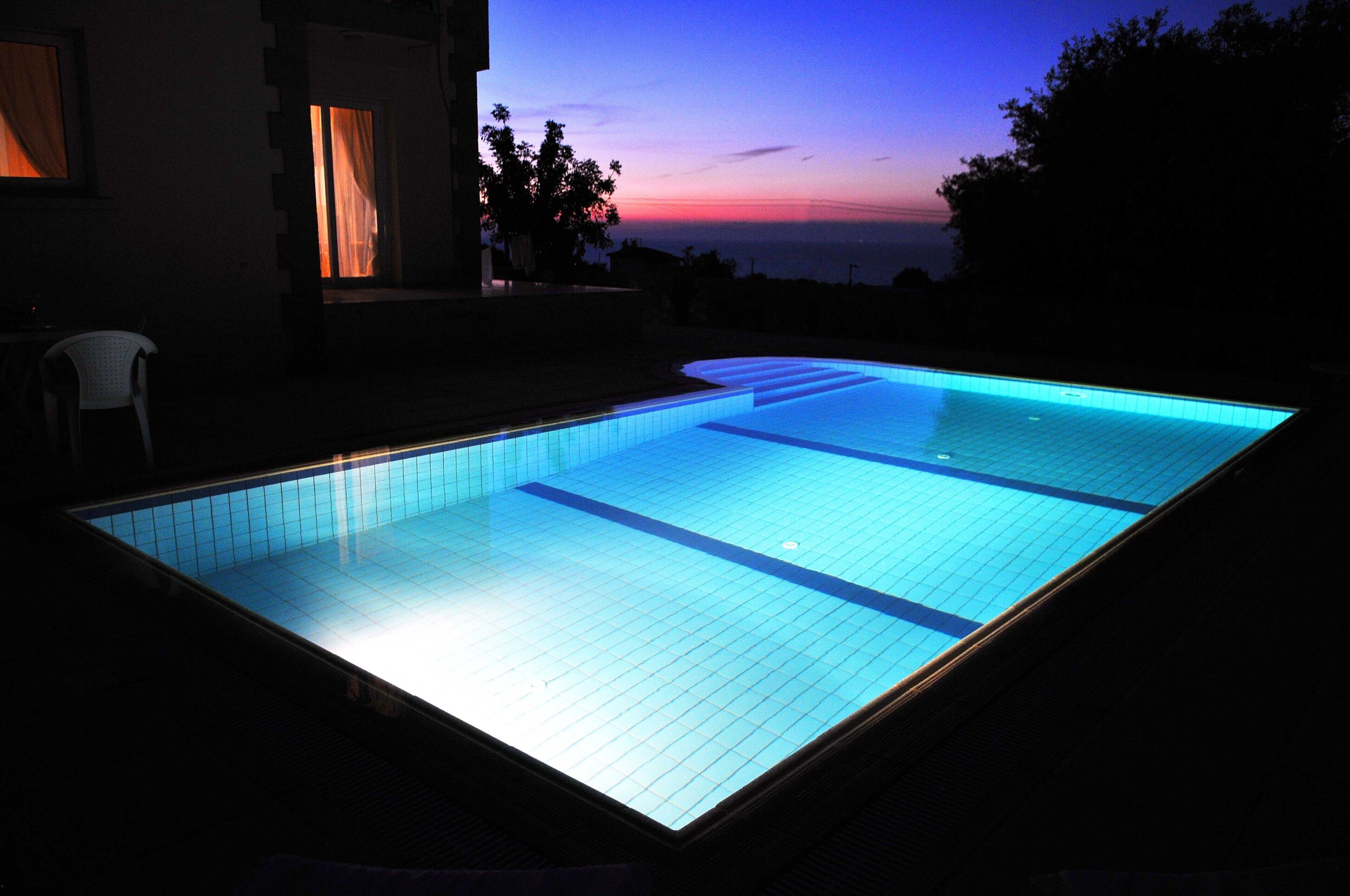 Stunning view of swimming pool at sun set 