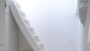 A white staircase leading to an attic space with a sloped ceiling. - charming fisherman house (Gruissan)