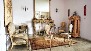 A room with ornate furniture, a large mirror, and a red decorative item on the wall. - The best choice for your vacation in Venice! (Venezia)