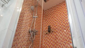 A shower with a glass door and a tiled wall. - Charm and garden view, in the center of Paris, near Montparnasse (Paris)