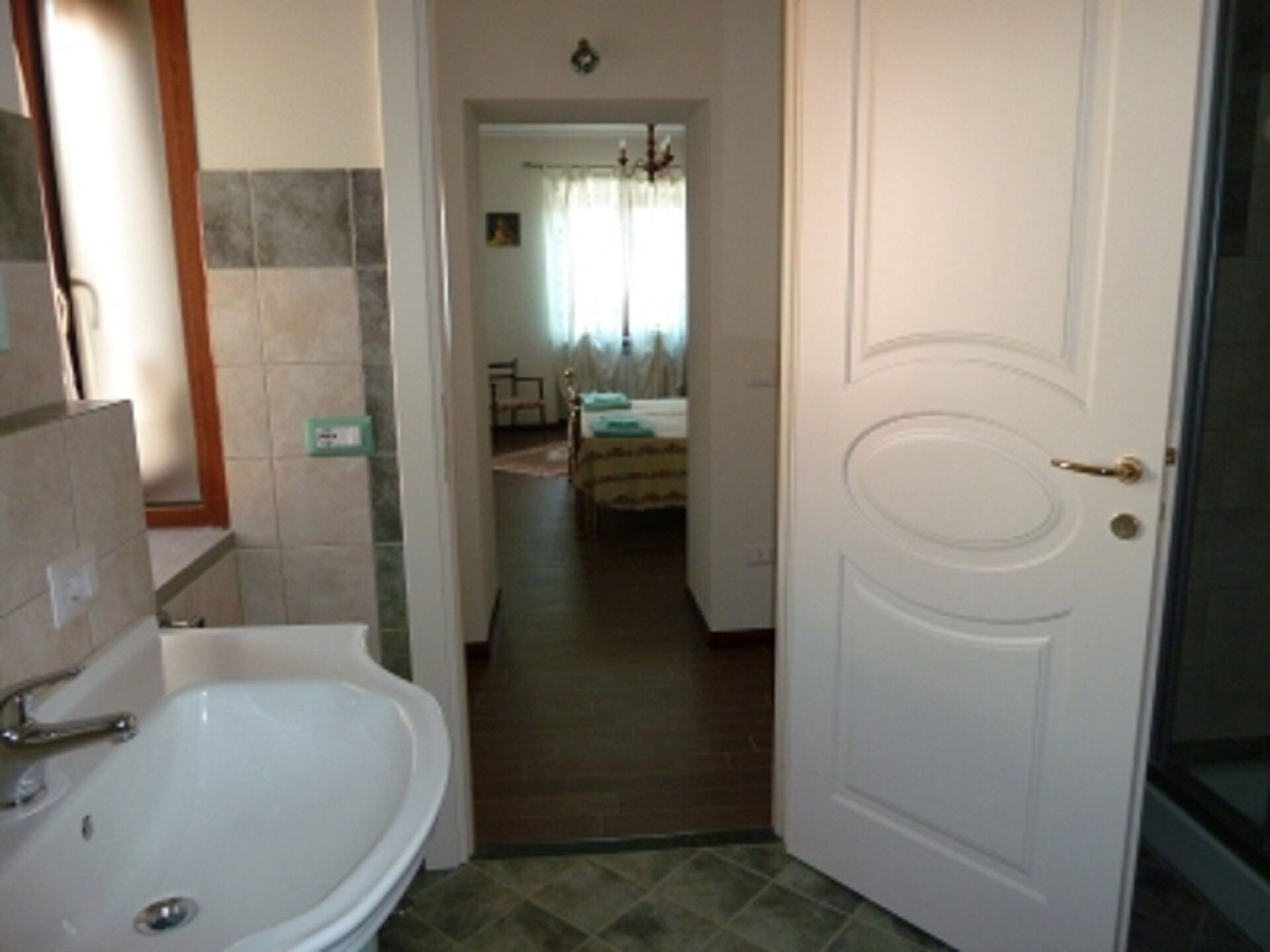 A bathroom with a sink and a shower.