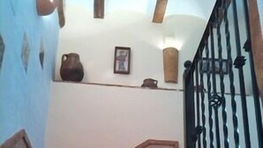 A staircase with wooden steps and a black metal railing.