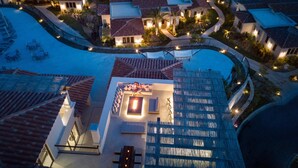 A resort with multiple buildings, a swimming pool, and outdoor seating areas. - Live Aqua Private Residences Los Cabos (Cabo San Lucas)