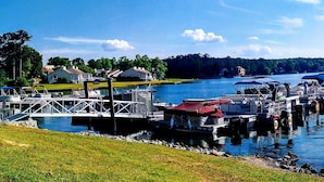 A marina with docked boats, a bridge, and a sign for Dockside Marina Restaurant & Bar. - Fairfield Plantation Resort (Villa Rica)