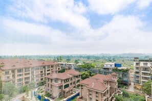 A residential complex with multiple apartment buildings, a swimming pool, and a view of the surrounding landscape. - Qingshen Hotel (Qingshen)