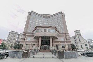 A multi-story hotel with a prominent entrance, a central staircase, and a symmetrical facade. - Qingshen Hotel (Qingshen)