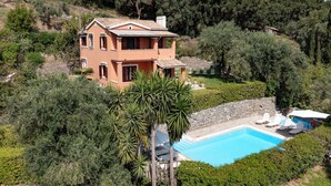 A two-story house with a swimming pool, surrounded by greenery and hills. - Stathis House - Ag. Georgios Corfu (Pagi)