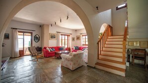 A spacious living room with a high arched ceiling, a staircase, and a piano. - Stathis House - Ag. Georgios Corfu (Pagi)