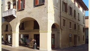 A historic building with multiple arches and a balcony.