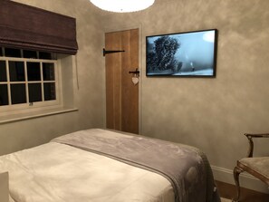 Cozy retreat with a bed, wooden door, and large window.