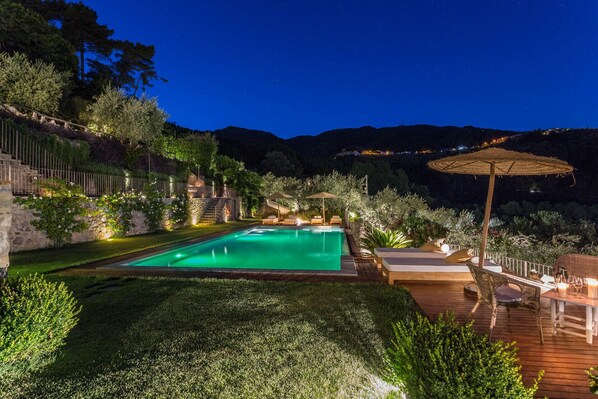 An infinity pool, sun loungers