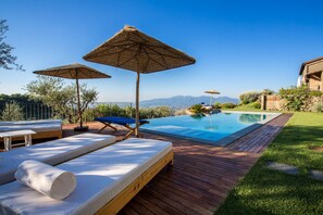 An infinity pool, sun loungers