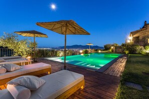 An infinity pool, sun loungers