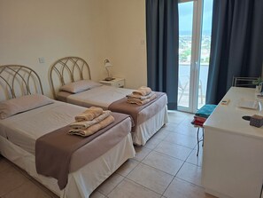 A hotel room with two beds, a desk, and a view of the city. - 5 * villa with sea views to take your breath away near Coral Bay in Peyia .  (Napoleontos, Reiza Village)