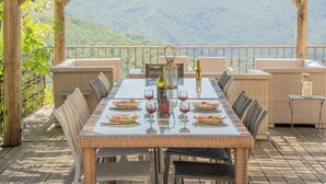A dining table set for six with chairs, a bottle of wine, and a candle holder. - Mansion - SORBOLLANO (Sorbollano)