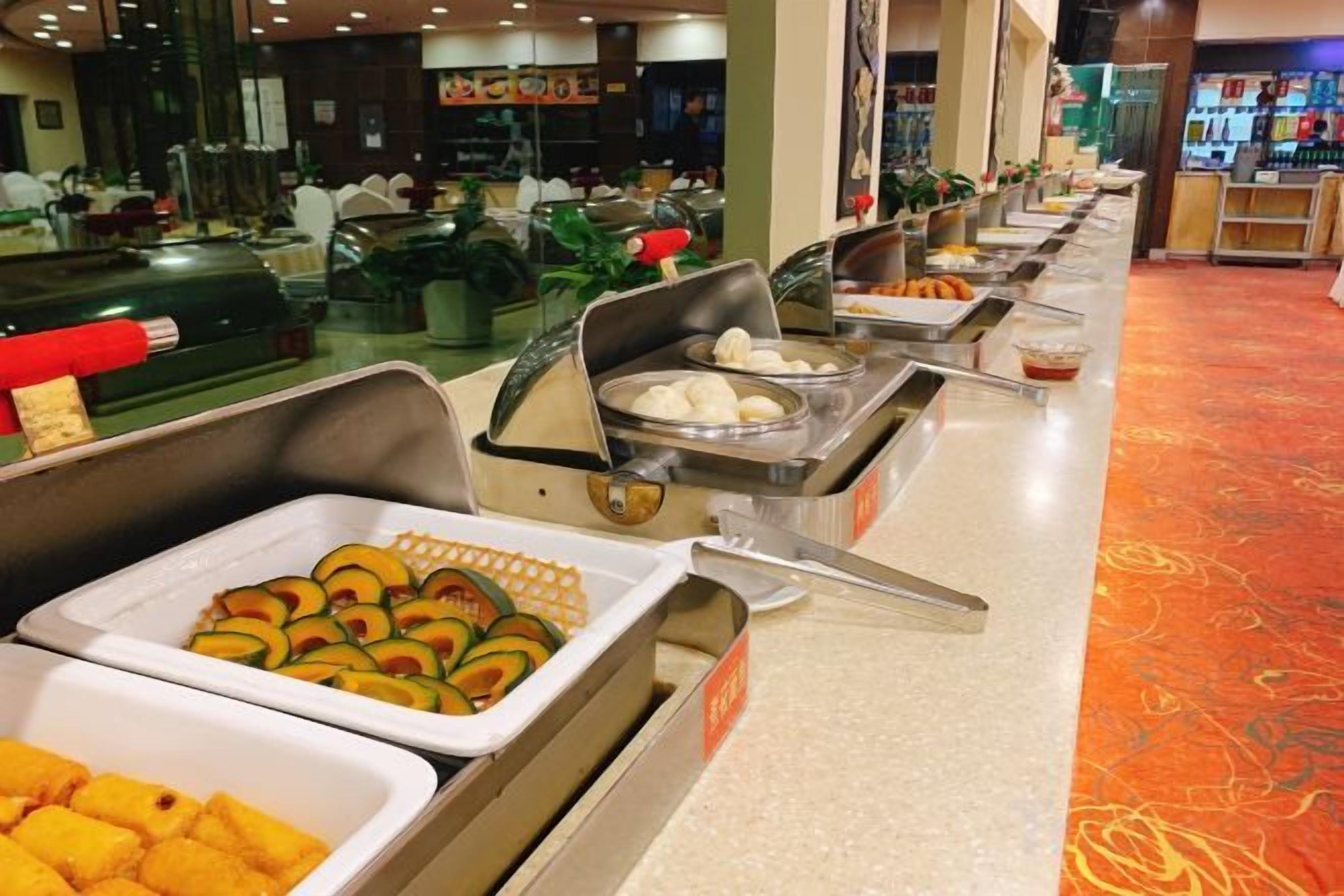 A buffet with various food items and a counter.