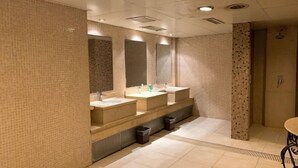 A modern bathroom with three sinks, a large mirror, and a shower area. - Hongqi Hotel (Datong)