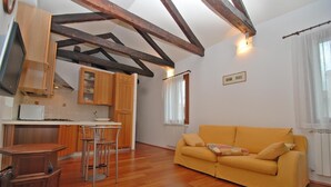 A compact living space with a kitchen, dining area, and a sofa. - Formosa Apartment: A Wonderful Holiday in the Heart of Gorgeous Venice (Venezia)
