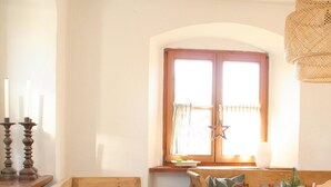 A cozy kitchen with a wooden bench, a white table, and a window with curtains. - Historic Burggen vicarage with large garden, near Neuschwanstein Castle (Burggen)