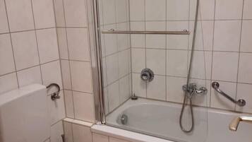 Bathtub, hair dryer, towels, soap