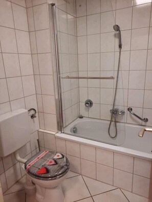 Bathtub, hair dryer, towels, soap