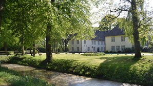 A large building with multiple windows and a well-maintained lawn.