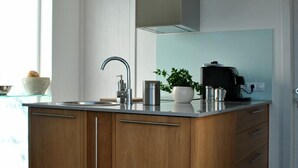A modern kitchen with a wooden island, stainless steel appliances, and a pendant light. - HOLIDAYS WITH VISION AND --RUHIG ENTSPANNEND-- COMFORTABLE AND QUALITY  (Tijarafe)