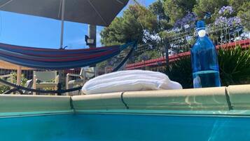 Seasonal outdoor pool, open noon to 8:00 PM, pool umbrellas