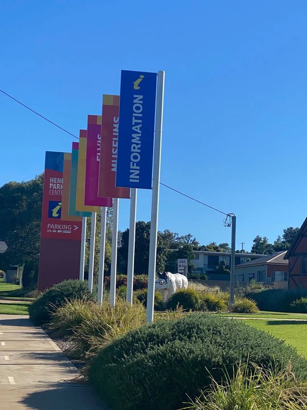 A series of directional signs for a park center, including parking and information directions.