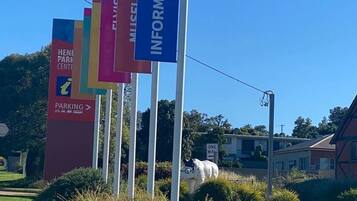 A series of directional signs for a park center, including parking and information directions.