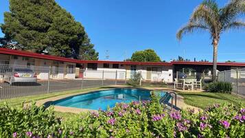 Seasonal outdoor pool, open noon to 8:00 PM, pool umbrellas