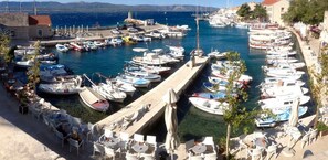 Enjoy waterfront views of the marina with its tranquil harbor, seating areas, and traditional architecture.