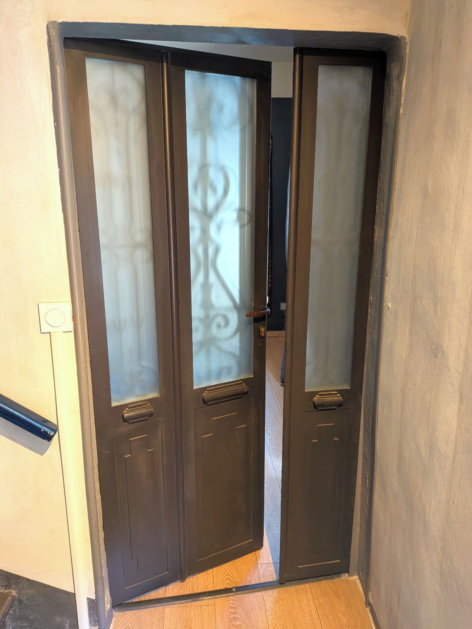 A double door with frosted glass panels and a metal handle.