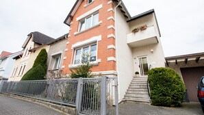 A two-story residential building with a brick facade, white trim, and a small front porch. - Apartment Hörster in the center of Detmold (Detmold)