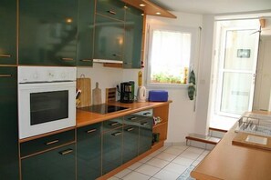 A kitchen with a built-in oven, a window, and a sink. - Beautiful house with idyllic views G0268 (Lacanau)