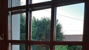 A room with a large window, a wicker basket, and a wooden shelf. - Holiday home in one of the most unspoilt landscapes in France. (Chaspinhac)